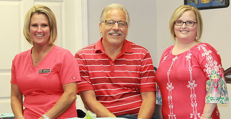 Pediatric dentist Dr. Gregory J. Kuchtjak with two staff members